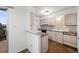 Galley style kitchen with light wood cabinets and appliances at 3855 S Monaco St # 176, Denver, CO 80237
