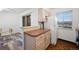 View of kitchen with light wood cabinets and access to the backyard at 3855 S Monaco St # 176, Denver, CO 80237