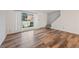 Living room with hardwood floors, large window and a view to the backyard at 3855 S Monaco St # 176, Denver, CO 80237