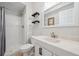 Bathroom with shower, shelves, toilet, and vanity with sink offers a clean and functional space at 3418 Oak Leaf Pl, Highlands Ranch, CO 80129
