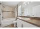 Updated bathroom with bathtub-shower combo, stylish tile, and single sink vanity at 3418 Oak Leaf Pl, Highlands Ranch, CO 80129