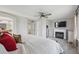 Cozy bedroom features a fireplace, TV, and ensuite bathroom access at 3418 Oak Leaf Pl, Highlands Ranch, CO 80129