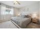 Relaxing bedroom features a neutral palette, plush carpeting, and a bright window for natural light at 3418 Oak Leaf Pl, Highlands Ranch, CO 80129