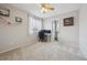 Bright bedroom with a ceiling fan, window, and view into an attached ensuite bathroom at 3418 Oak Leaf Pl, Highlands Ranch, CO 80129