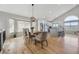 Bright dining room featuring stylish decor, vaulted ceilings, hardwood floors, and mountain views at 3418 Oak Leaf Pl, Highlands Ranch, CO 80129