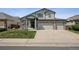Charming two-story home with a three car garage, landscaped yard, and an American flag at 3418 Oak Leaf Pl, Highlands Ranch, CO 80129