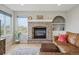 Inviting living room featuring a brick fireplace, decor, and comfortable seating at 3418 Oak Leaf Pl, Highlands Ranch, CO 80129