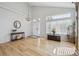 Bright foyer featuring stylish decor, vaulted ceilings, and beautiful hardwood floors at 3418 Oak Leaf Pl, Highlands Ranch, CO 80129