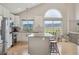Modern kitchen featuring white cabinetry, stainless steel appliances, and a center island with bar stool seating at 3418 Oak Leaf Pl, Highlands Ranch, CO 80129