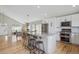 Open-concept kitchen and dining area featuring an island with seating and stainless steel appliances at 3418 Oak Leaf Pl, Highlands Ranch, CO 80129
