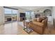 Cozy living room with a brick fireplace, TV, sliding door to deck, and scenic mountain views at 3418 Oak Leaf Pl, Highlands Ranch, CO 80129