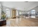 Bright living room featuring stylish decor, vaulted ceilings, and beautiful hardwood floors at 3418 Oak Leaf Pl, Highlands Ranch, CO 80129