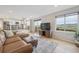 Open living space with a fireplace, deck access, and an open kitchen at 3418 Oak Leaf Pl, Highlands Ranch, CO 80129