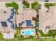 Aerial view of a private backyard featuring a swimming pool, patio, and solar panels at 8993 Stonecrest Way, Highlands Ranch, CO 80129