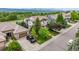 Aerial view of home with lush landscaping, solar panels, and a three car garage at 8993 Stonecrest Way, Highlands Ranch, CO 80129