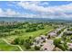 Scenic aerial view highlighting the golf course community, homes, and mountain views beyond at 8993 Stonecrest Way, Highlands Ranch, CO 80129