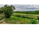 Expansive backyard with lush green lawn, black metal fence, and scenic golf course views at 8993 Stonecrest Way, Highlands Ranch, CO 80129