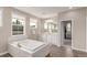 Modern bathroom featuring a soaking tub and updated vanity with double sinks at 8993 Stonecrest Way, Highlands Ranch, CO 80129