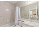 Full bathroom featuring a shower-tub combo, neutral tiling, and a large mirror at 8993 Stonecrest Way, Highlands Ranch, CO 80129