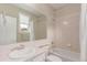 Tiled bathroom featuring a bathtub, shower, toilet, and vanity sink with neutral wall coloring at 8993 Stonecrest Way, Highlands Ranch, CO 80129