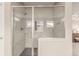 Modern bathroom with a glass shower, bench seat, and chrome shower head at 8993 Stonecrest Way, Highlands Ranch, CO 80129