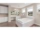 Bright bathroom featuring a soaking tub with a marble surround and a large vanity at 8993 Stonecrest Way, Highlands Ranch, CO 80129