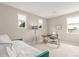 Light-filled bedroom with a daybed, desk, and three windows offering serene views at 8993 Stonecrest Way, Highlands Ranch, CO 80129