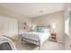 Cozy bedroom with a metal bed frame, carpet, and two windows at 8993 Stonecrest Way, Highlands Ranch, CO 80129