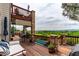 Spacious multi-level deck with stone pillars, golf course views, and comfortable seating area at 8993 Stonecrest Way, Highlands Ranch, CO 80129