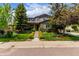Charming two-story home with stone accents, well-manicured lawn, and inviting entrance at 8993 Stonecrest Way, Highlands Ranch, CO 80129