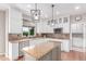 Modern kitchen featuring granite countertops, stainless steel appliances, and stylish light fixtures at 8993 Stonecrest Way, Highlands Ranch, CO 80129