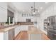 Bright kitchen boasts granite counters, white cabinetry, stainless appliances, and hardwood floors at 8993 Stonecrest Way, Highlands Ranch, CO 80129