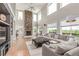 Spacious living room with stone fireplace and ample natural light at 8993 Stonecrest Way, Highlands Ranch, CO 80129