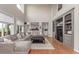Bright, open living room features a large sectional sofa, hardwood floors, and built-in shelving at 8993 Stonecrest Way, Highlands Ranch, CO 80129