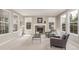 Comfortable living room with fireplace and windows at 8993 Stonecrest Way, Highlands Ranch, CO 80129