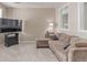 Comfortable living room with a large sectional sofa, TV, and carpet at 8993 Stonecrest Way, Highlands Ranch, CO 80129