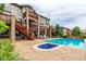 Backyard oasis with a sparkling pool, hot tub, and a spacious patio for entertaining at 8993 Stonecrest Way, Highlands Ranch, CO 80129