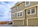 Exterior view of a townhome with multiple windows and attached garages at 1911 S Hannibal St # H, Aurora, CO 80013