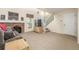 Comfortable living room featuring a brick fireplace, plush carpet, and staircase to the upper level at 1911 S Hannibal St # H, Aurora, CO 80013