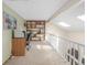 Upper loft area featuring a built-in bookcase and bright natural light at 1911 S Hannibal St # H, Aurora, CO 80013