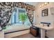 A relaxing bathroom showcasing a large soaking tub by a bay window, a vanity sink, and floral accents at 1000 N Logan St, Denver, CO 80203