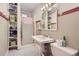 Functional bathroom with a stand-up shower, pedestal sink, and built-in storage shelves for organization at 1000 N Logan St, Denver, CO 80203