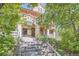 Charming home entrance with stone steps leading to the front door framed by lush greenery, creating an inviting welcome at 1000 N Logan St, Denver, CO 80203