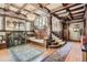 Cozy living room highlighting the fireplace, staircase, and rich wooden accents, offering a comfortable living space at 1000 N Logan St, Denver, CO 80203