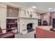 Office featuring a decorative white fireplace, exposed brick accents, and built-in bookcases at 1000 N Logan St, Denver, CO 80203
