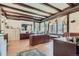 Large home office with wood floors, beamed ceilings, large windows, and built in cabinets at 1000 N Logan St, Denver, CO 80203