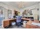 Large office with a spacious desk, couch, and charming decor with a chandelier at 1000 N Logan St, Denver, CO 80203
