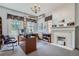 Well-lit office with a fireplace, large windows, and ample desk space at 1000 N Logan St, Denver, CO 80203