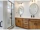 Elegant bathroom with double vanity, modern fixtures, and a walk-in shower at 11728 Octave Ave, Lone Tree, CO 80134