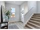 Bright entryway with stairs, wood-look floors, and decorative accents at 11728 Octave Ave, Lone Tree, CO 80134